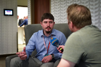 Petr Paščeno, Head of Data Science, is being interviewed by another person holding a microphone.